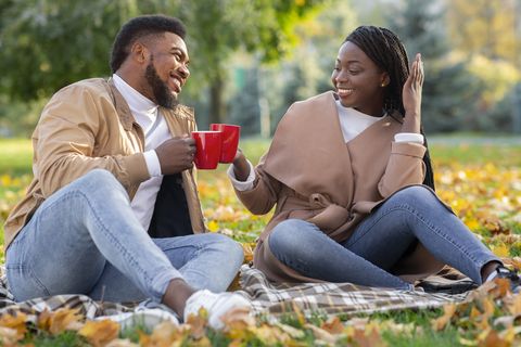 romantic afro couple spending time together in autumn park