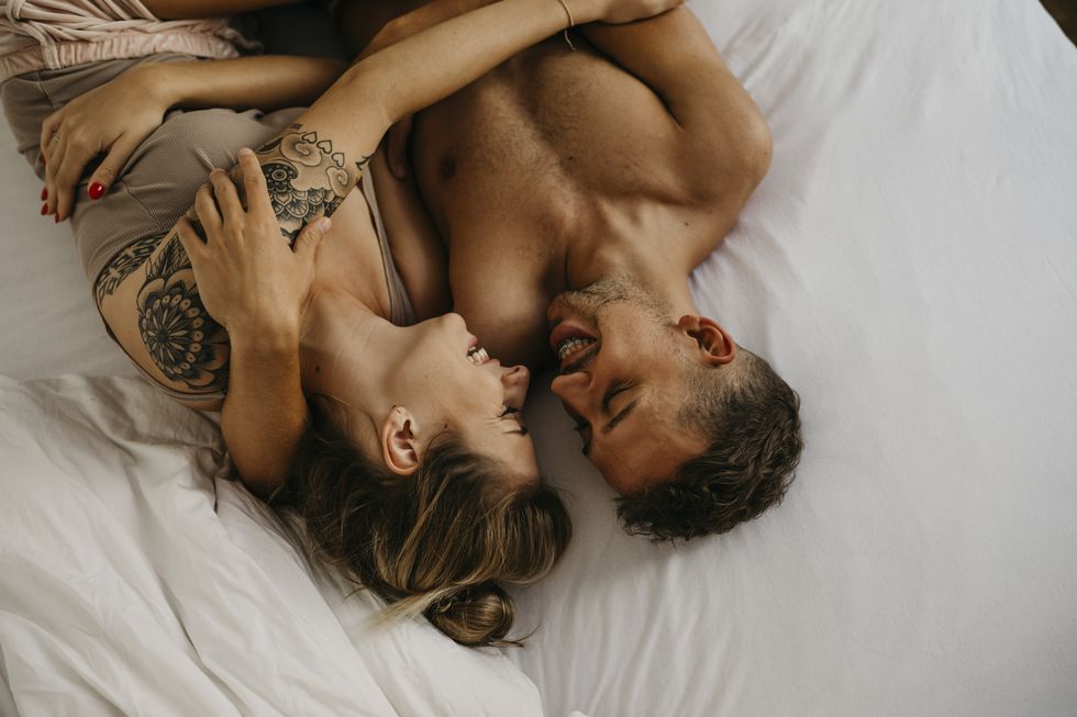romantic happy young couple lying in bed