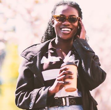 a woman wearing sunglasses and a suit