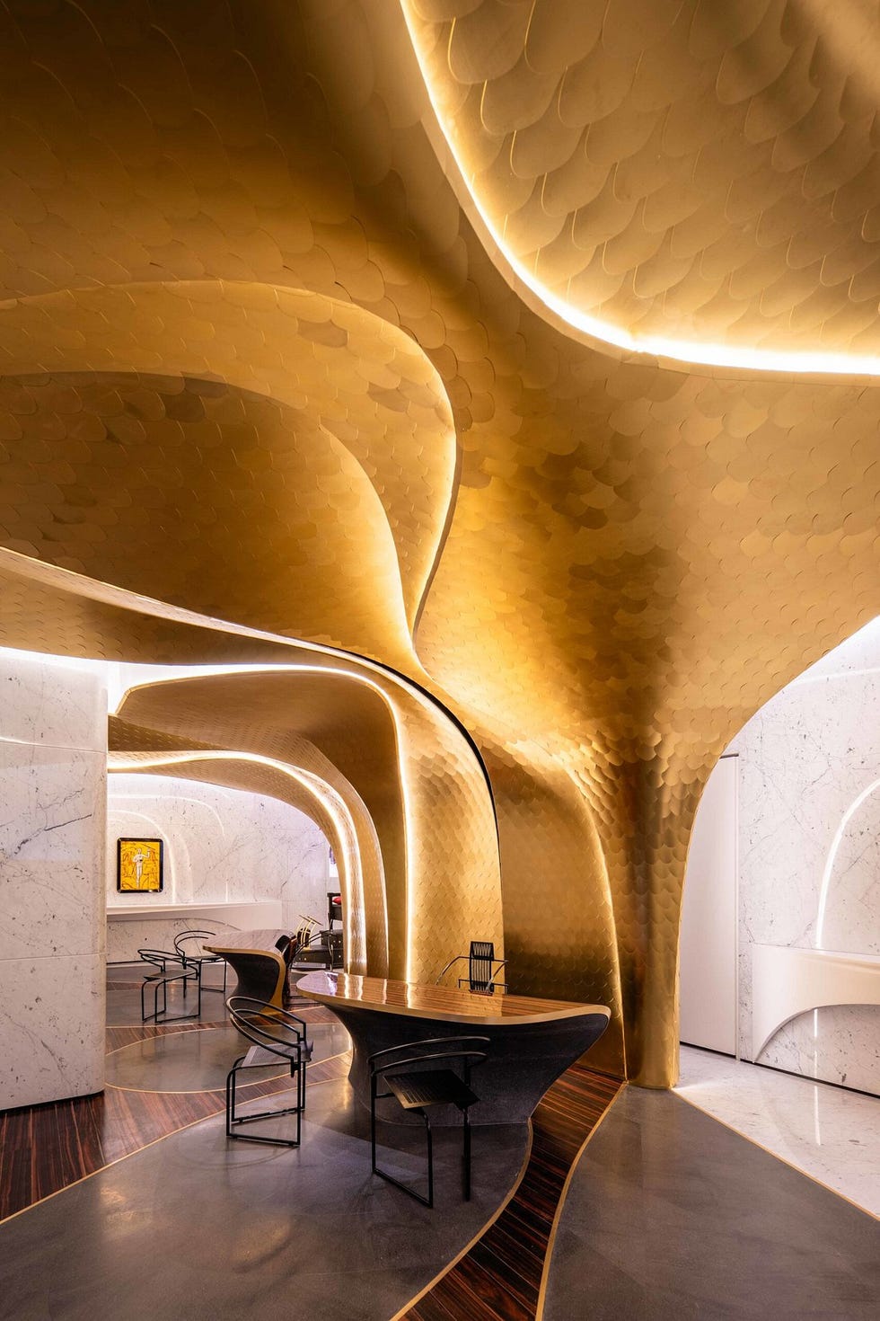 modern interior space featuring golden textured arches and sleek furniture