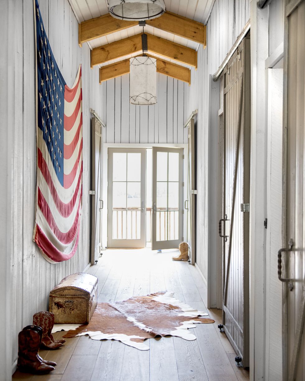large american flag hanging in white planked hallway