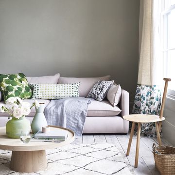 living room with a pale pink sofa and light coloured rug on the floor in frontfrom content by terence conran