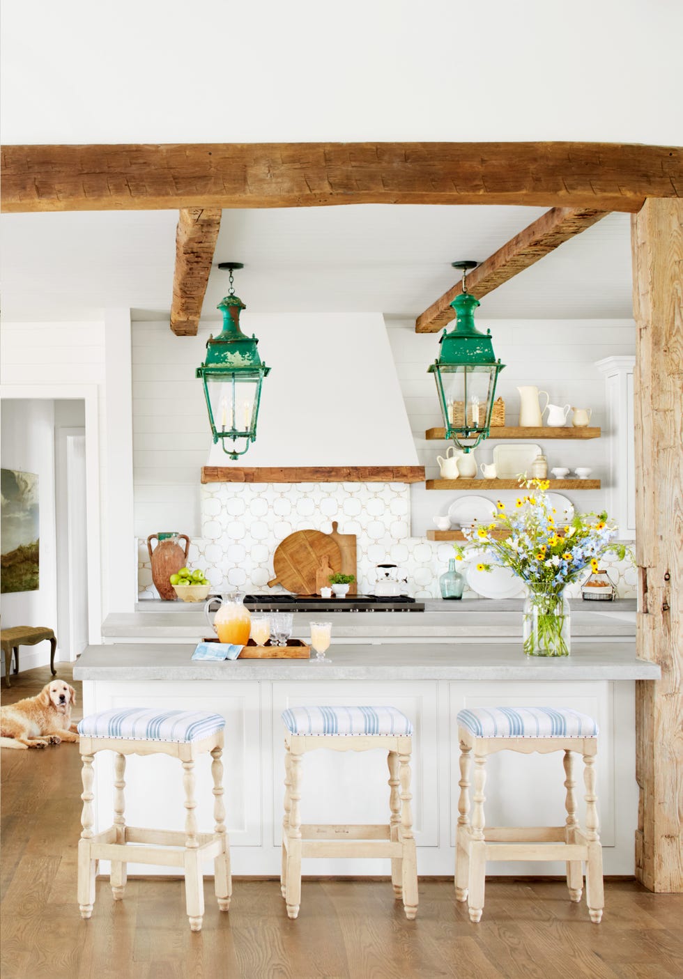 a white farmhouse kitchen with blue and white cushioned stools