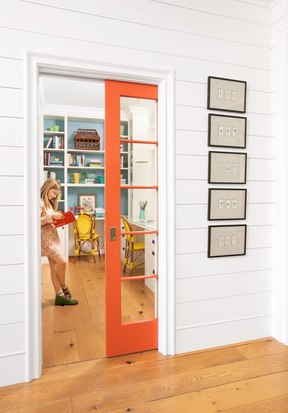 orange pocket door leading into an office