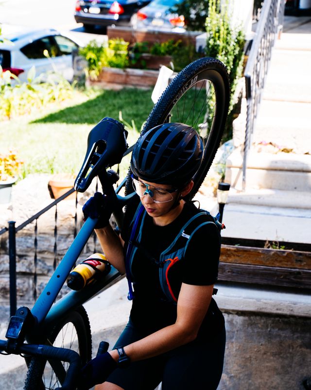 rosael torres davis bringing her mountain bike up the stairs in to her apartment in philadelphia﻿ in august 2022