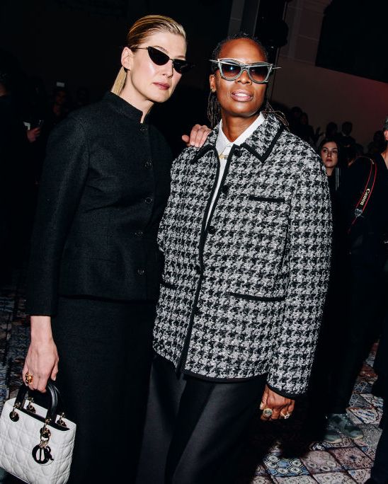 rosamund pike and mickalene thomas at the dior pre fall 2024 show front row wearing grey and black and sunglasses