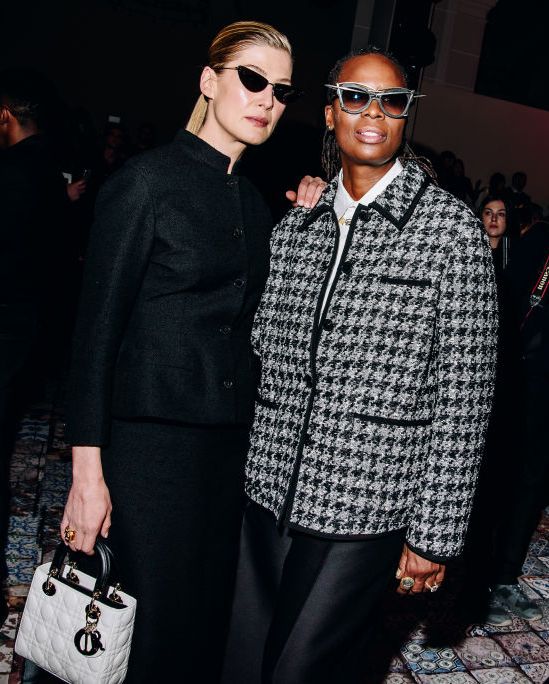 rosamund pike and mickalene thomas at the dior pre fall 2024 show front row wearing grey and black and sunglasses