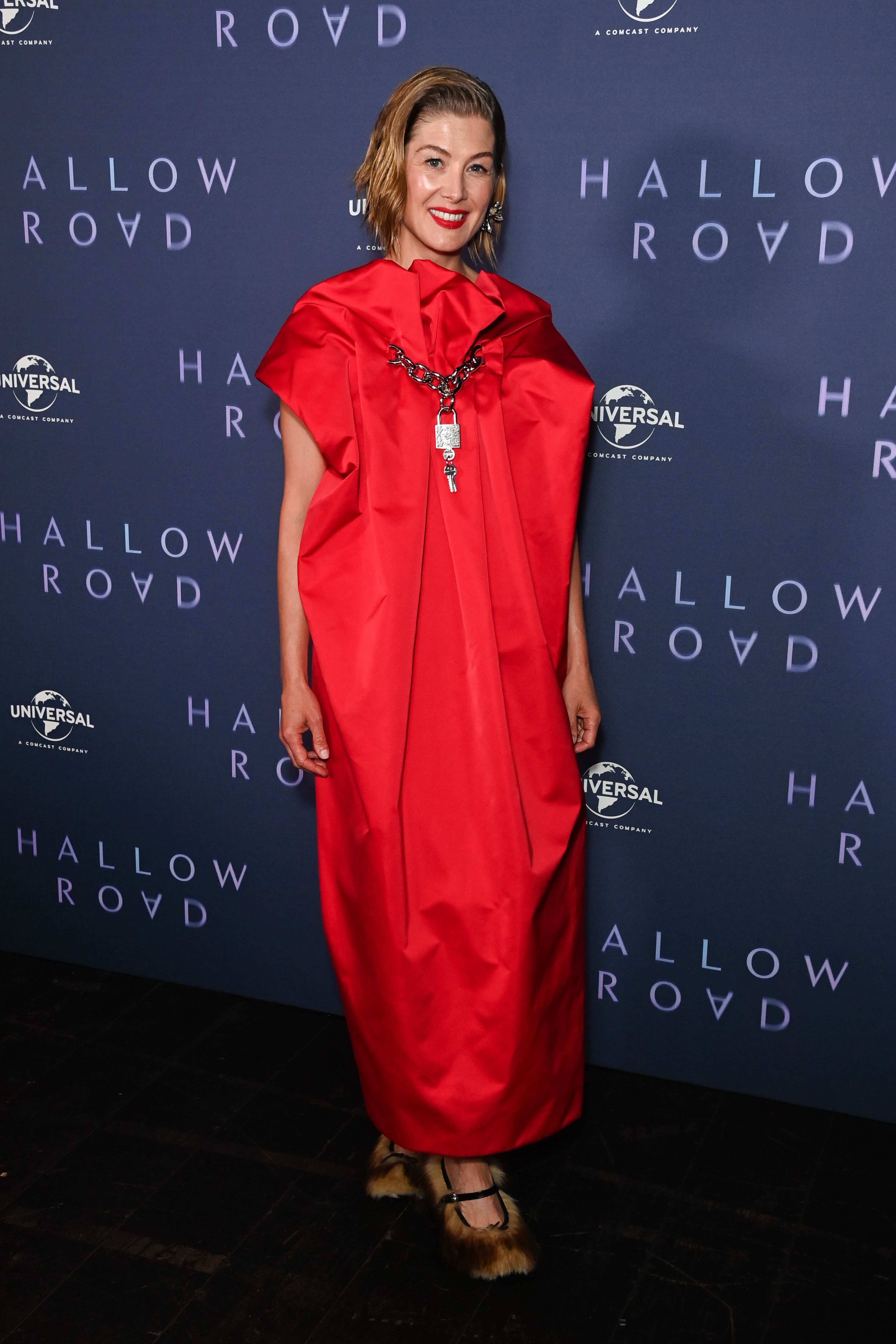 Rosamund Pike Adds Some Funk to Her Red-Carpet Gown With These Furry Slippers