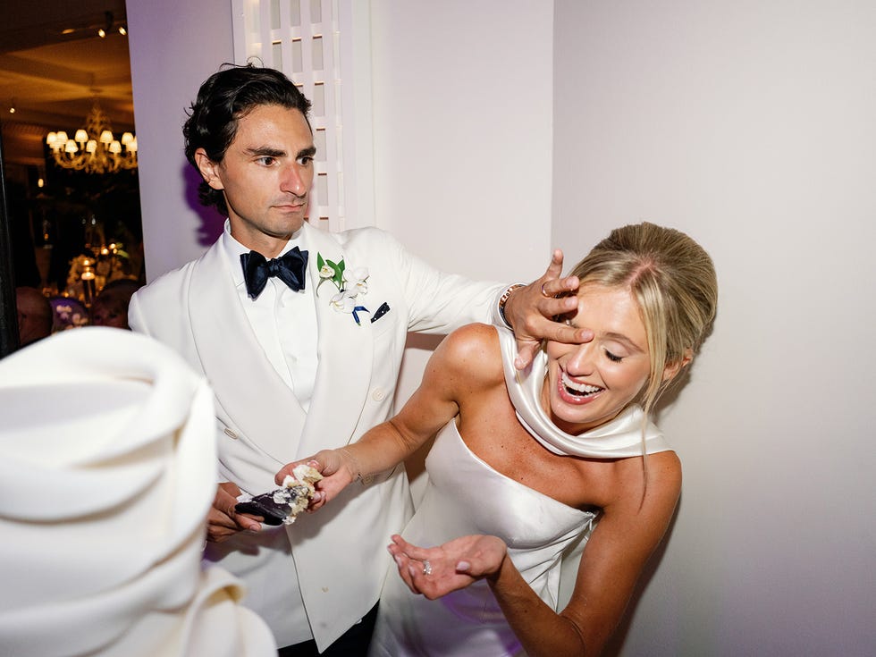 a couple celebrating an event with one holding cake