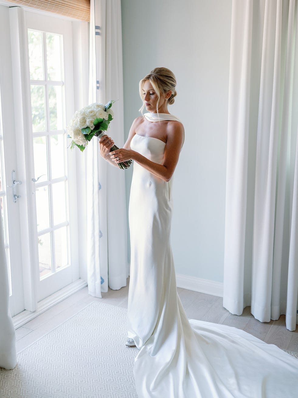 a person in a wedding dress holding a bouquet