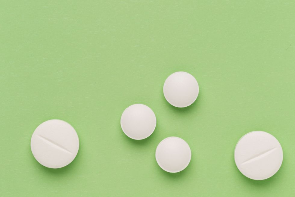 Round white pills on colorful background
