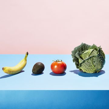 A row of different fruits and vegetables on a table top
