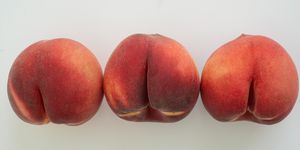 a row of white peaches on white surface