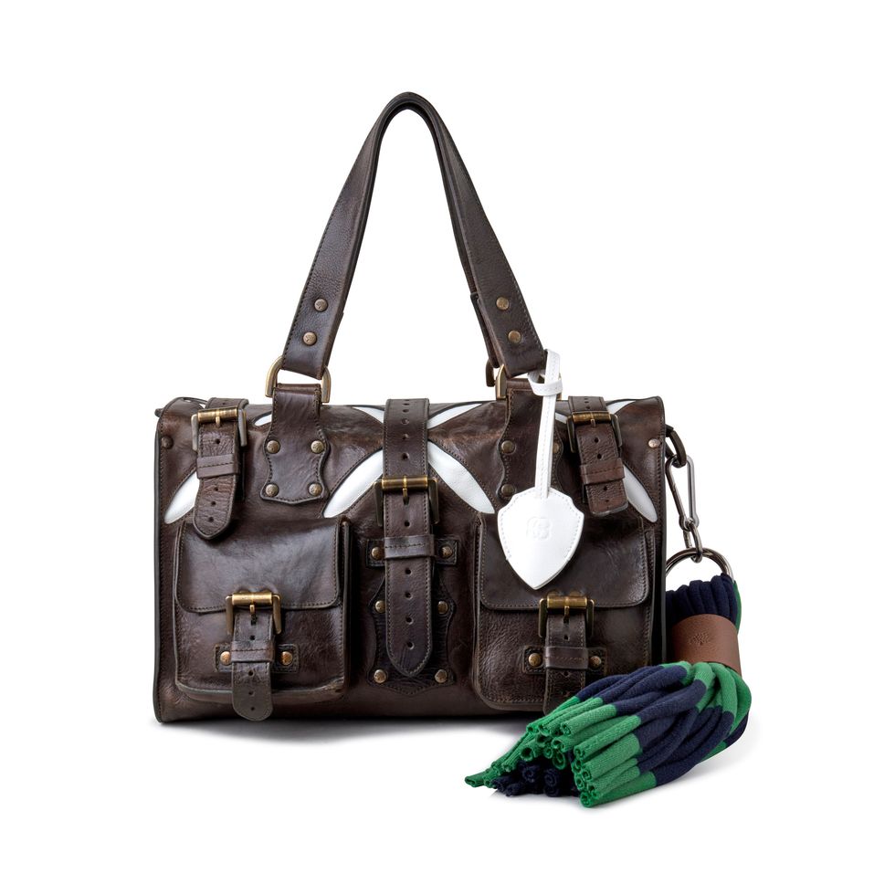 a brown handbag with a green strap