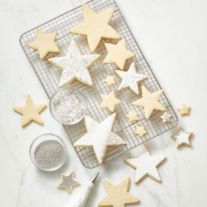 star cookies with icing on top of a wire rack