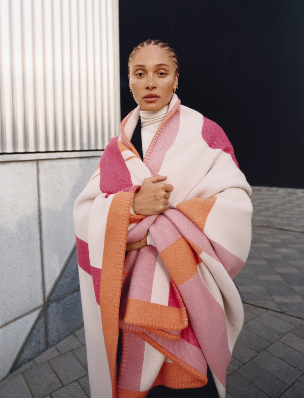 person wrapped in a colorful blanket with geometric patterns