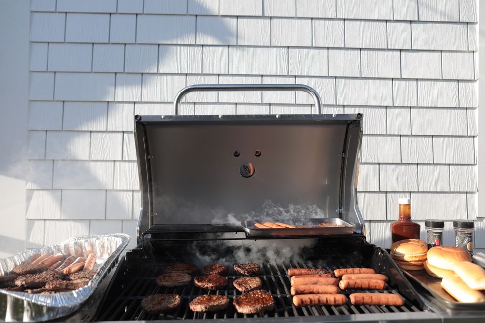 a grill with hot dogs