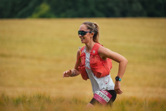 smiling woman running in a field