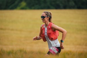 smiling woman running in a field