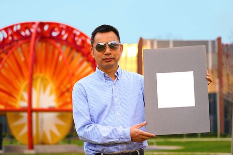 xiulin ruan, a purdue university professor of mechanical engineering, holds up his lab’s sample of the whitest paint on record purdue universityjared pike