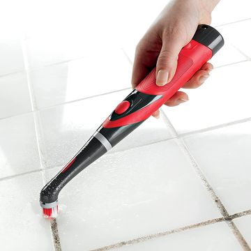 using rubbermaid scrubber to clean grout on white tile