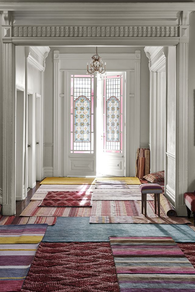 sunny room with a number of vibrants rugs