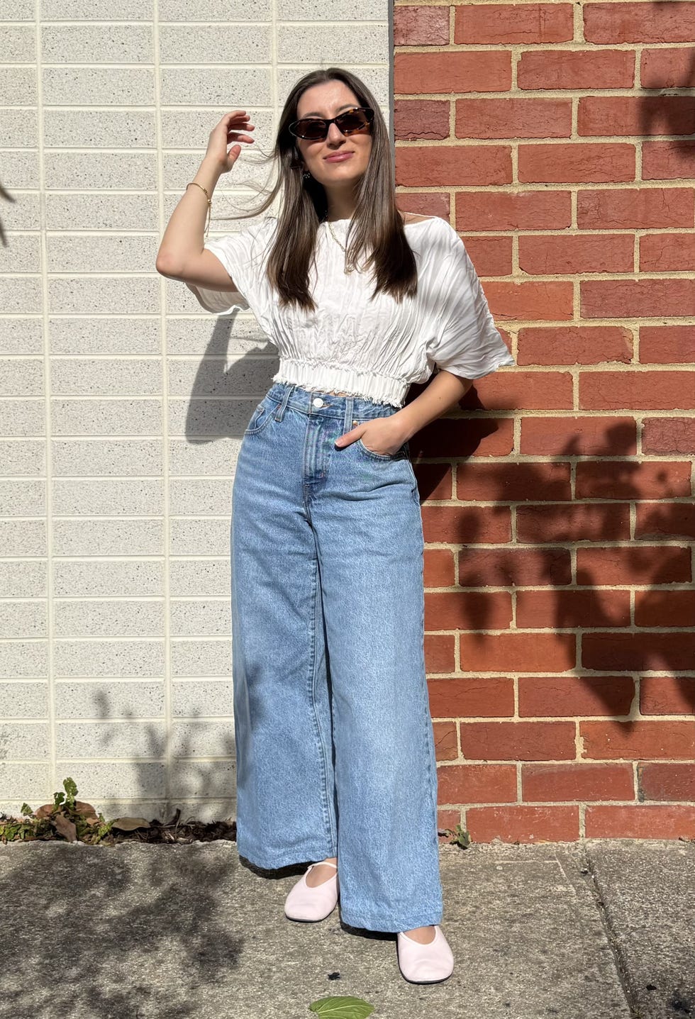 zoe anastasiou wears high waist jeans and a crop top