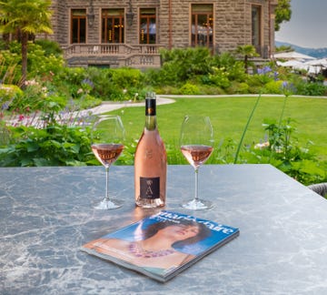 a bottle of wine and glasses on a table