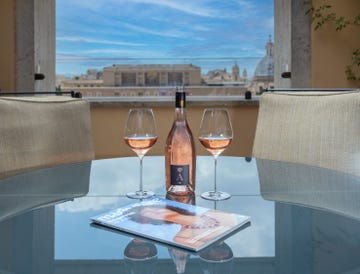 a table with wine glasses and a bottle of wine on it