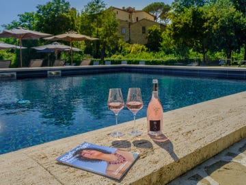 a pool with a bottle and glasses