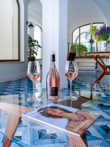 a table with wine glasses and a bottle of wine on it