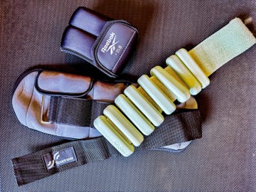 assorted brands of ankle weights on a textured surface