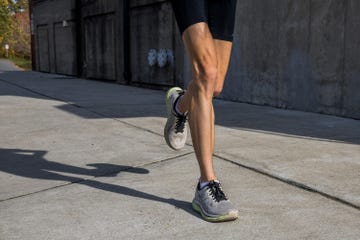 a person running in asics glideride max running shoes