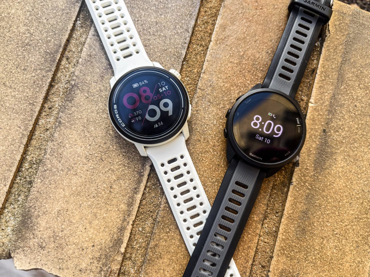 a pair of basic running watches on a textured surface