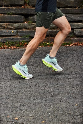 a person running in a pair of nike alphafly 2 running shoes
