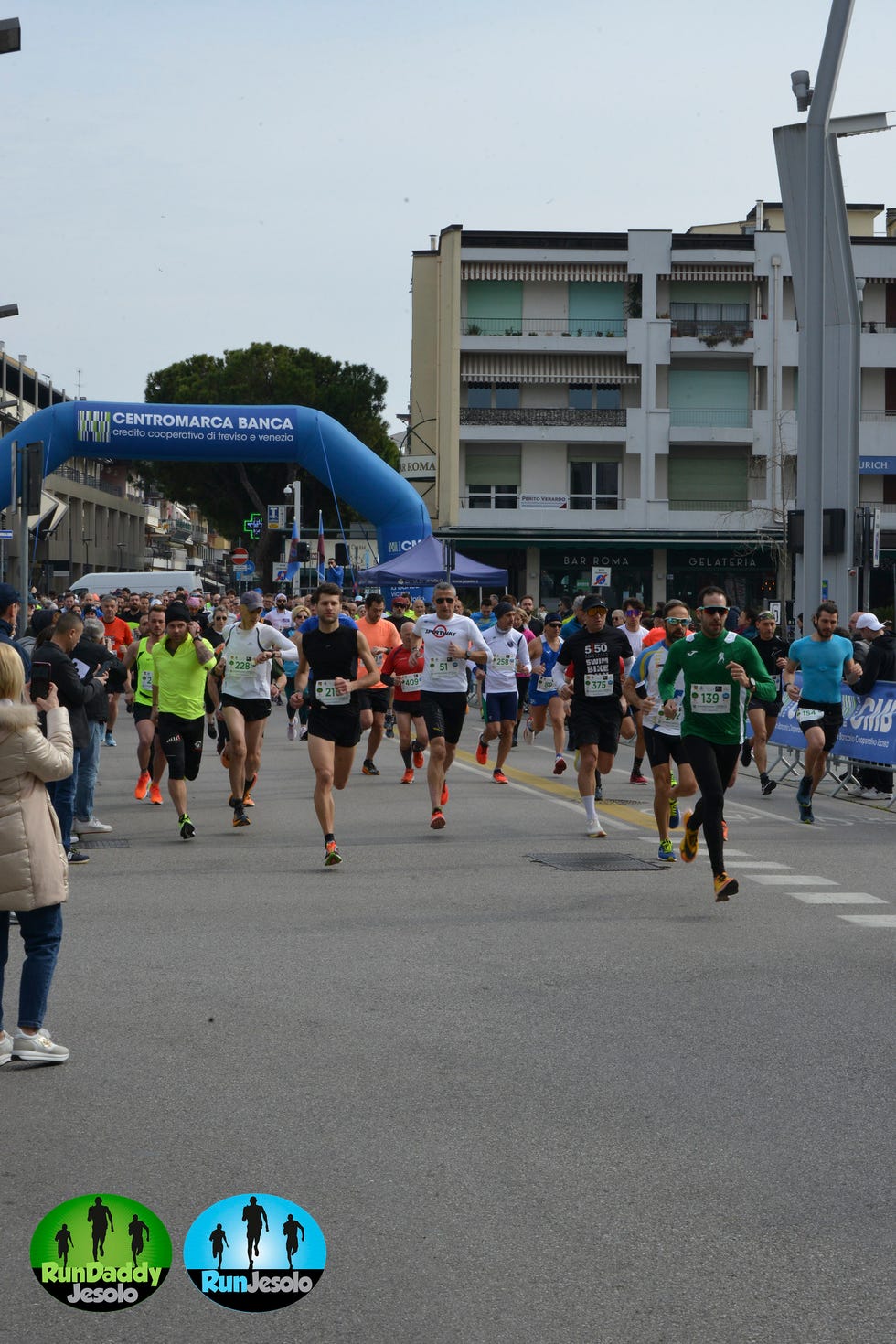 a group of people running in a street