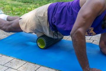 a person using a foam roller on their thigh