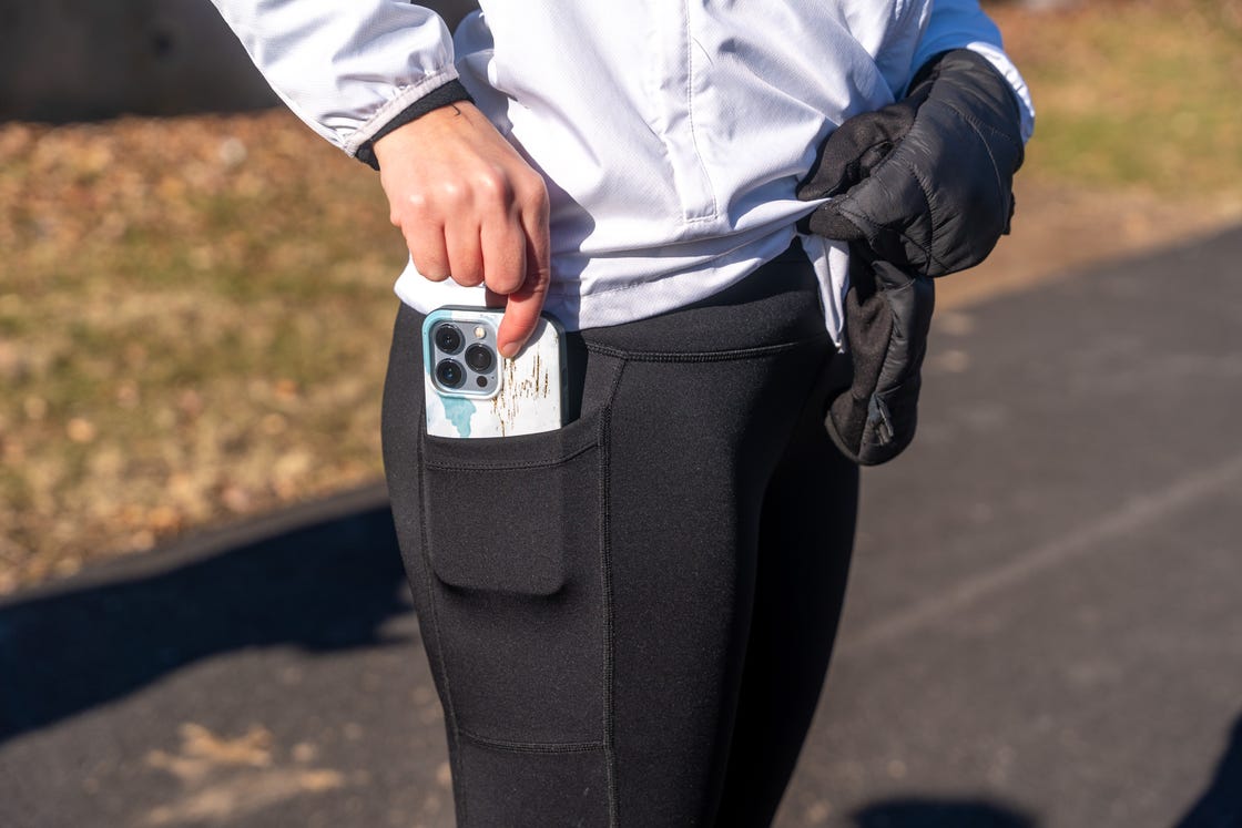 smartphone partially visible in the pocket of athletic leggings