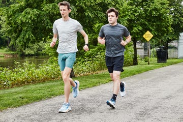 two men running on a gravel road