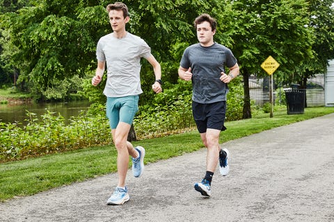 two men running on a gravel road