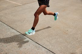 a woman running in mizuno wave rebellion pro 3 running shoes