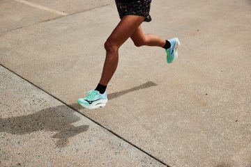 a woman running in mizuno wave rebellion pro 3 running shoes
