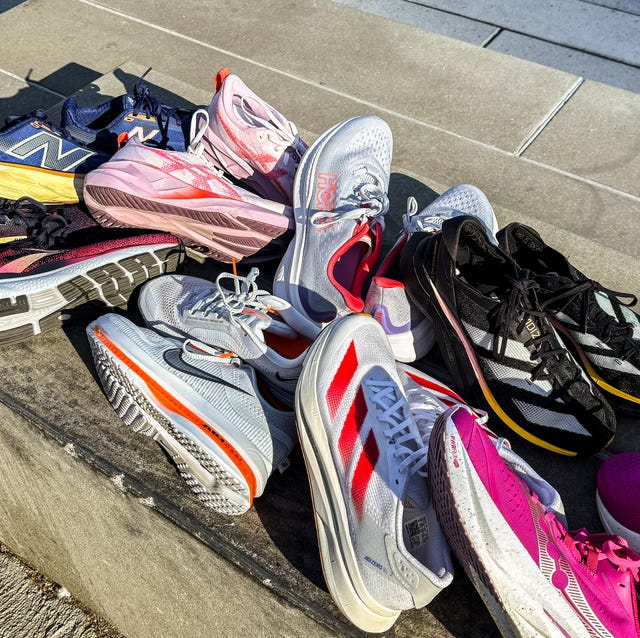 best running shoes for narrow feet a group of narrow feet running shoes piled on a concrete bench