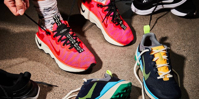 a person's feet with Nike coral shoes