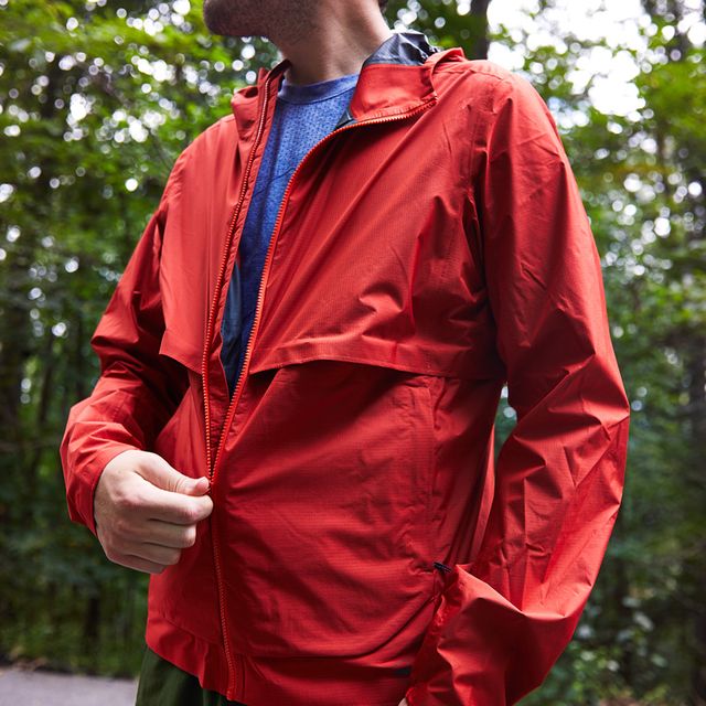 pulling up zipper on red running jacket