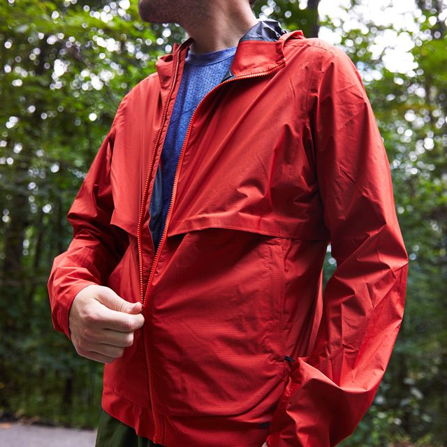 pulling up zipper on red running jacket
