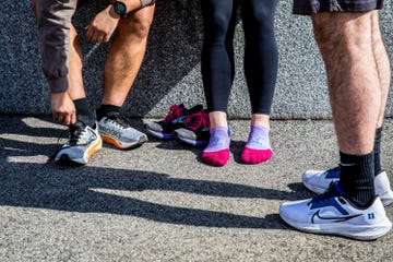 runners in socks putting on shoes