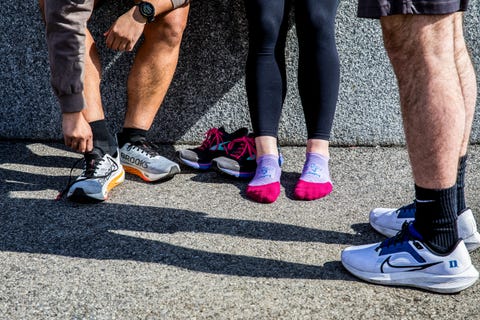 runners in socks putting on shoes