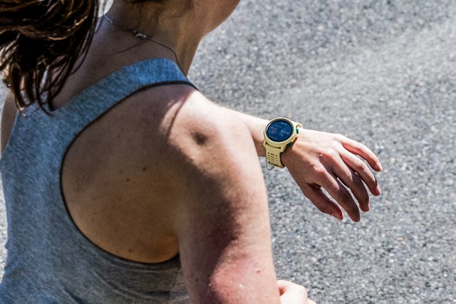 a woman running with her coros pace running watch