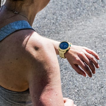 Best Running Watches a woman running with her coros pace running watch